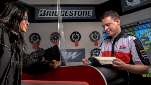 A tiger wheel and tyre employee consulting with a customer