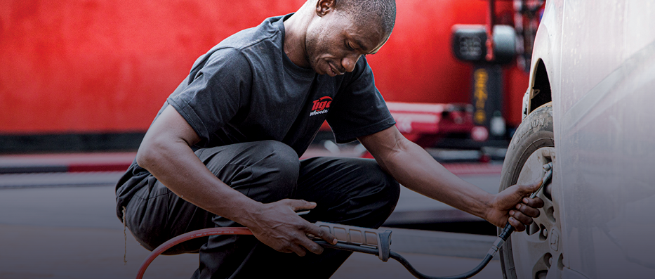 A tiger wheel and tyre technician filling a tyre with nitrogen